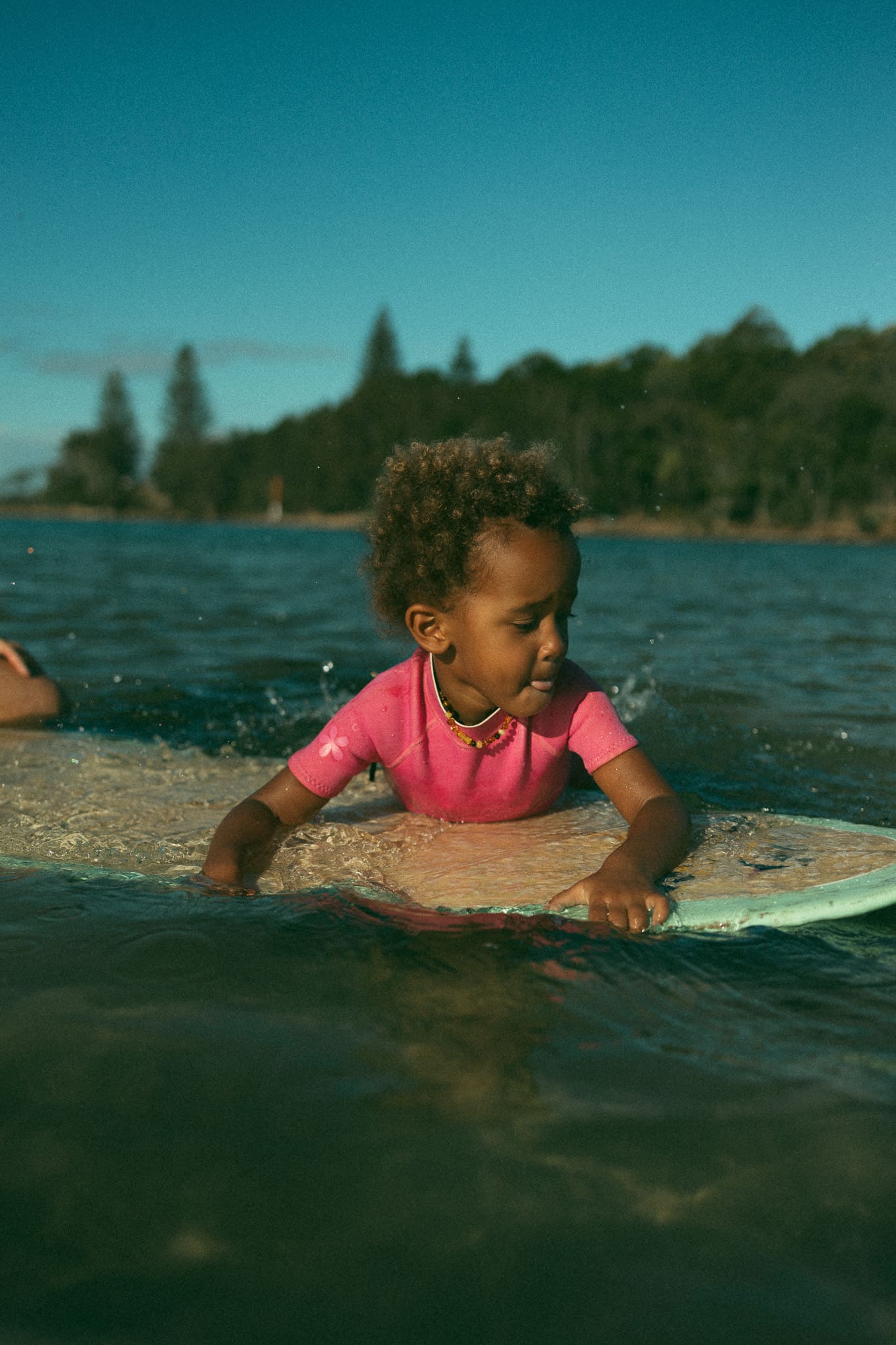 Child on surf board in Evans Head NSW