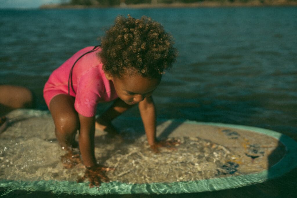 Little girl on a surf board in Evans Head NSW