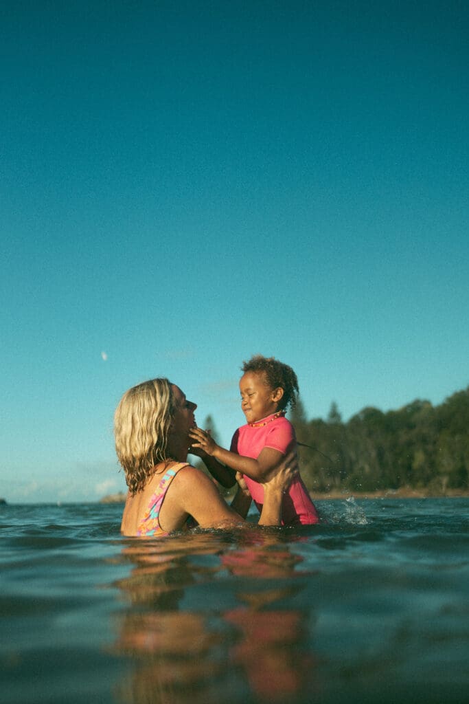 Mother and daughter having fun in the ocean in Evans Head