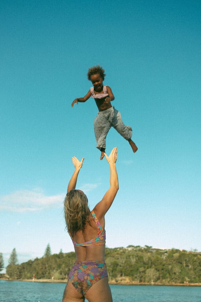 Mother thowing her child up into the sky before catching her in Evans Head NSW