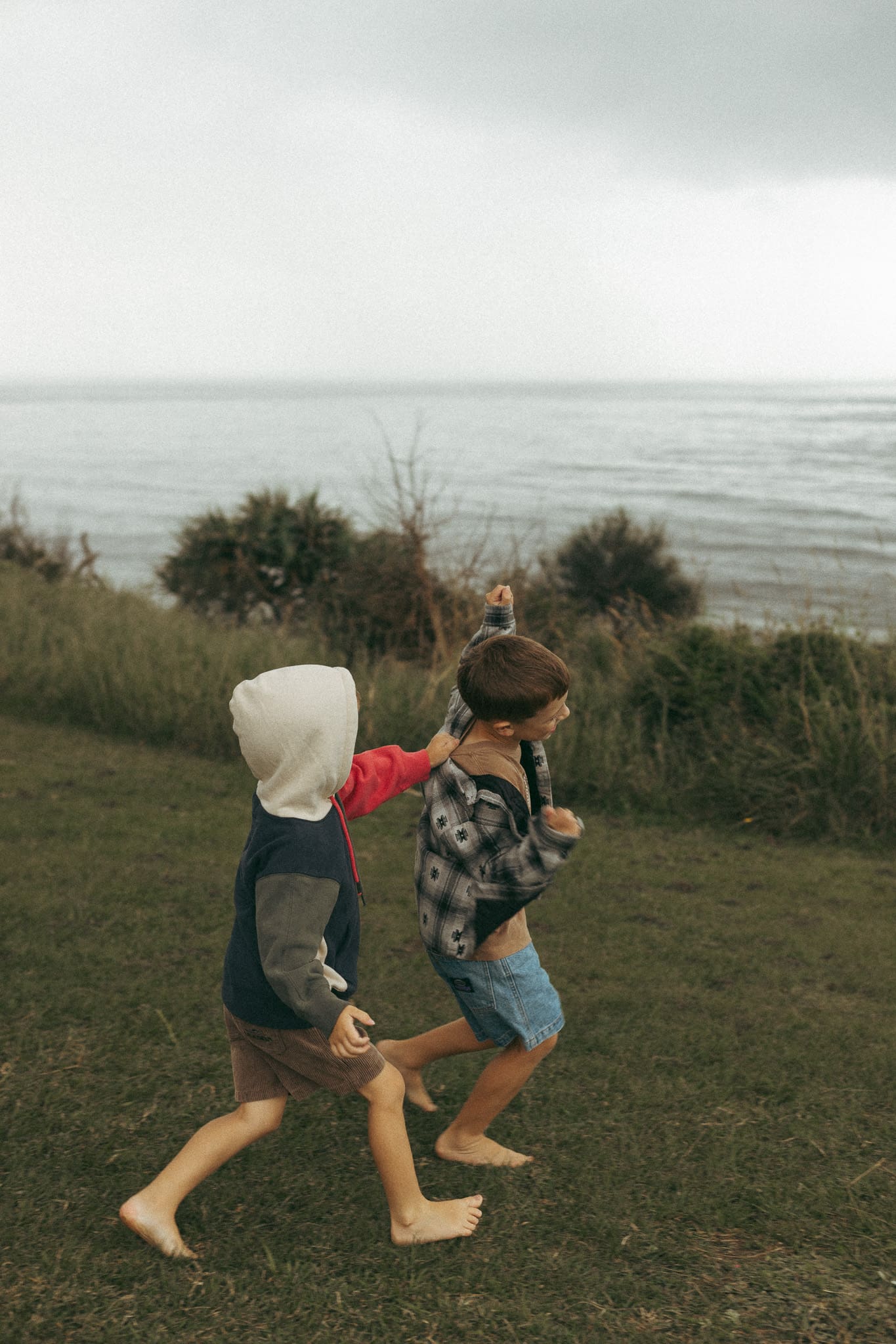 Two brothers on Razorback lookout in Evans Head, playing and running around wearing Ghanda